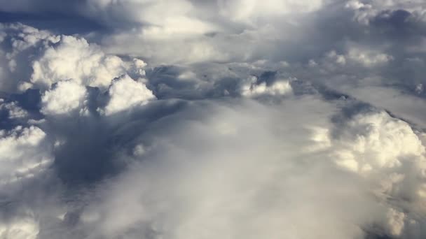 Lenyűgöző felvételek a felhők feletti légi felvételekről. Kilátás a repülőgép ablakából a kék égre és a fehér felhőkre. Gyönyörű ég és felhők felett repül. Légi felvétel a gépről. — Stock videók