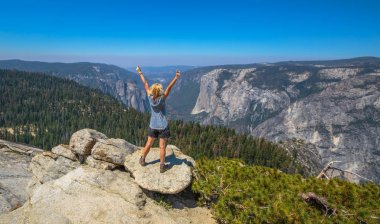Enjoying at Yosemite summit clipart