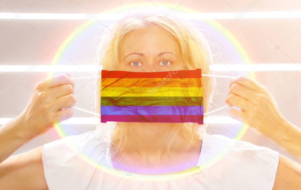 Woman with rainbow flag surgical mask on white