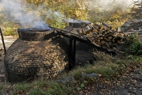 The production of charcoal in a traditional manner in the forest