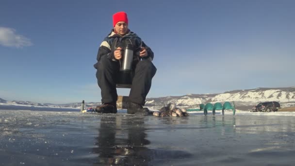 Fisherman is a man in winter fishing. — Stock Footage Fisherman is a man in winter fishing. Royalty Free Stock Video