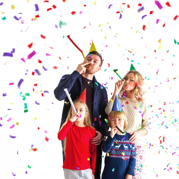 Family blowing party trumpets — Stock Photo, Image