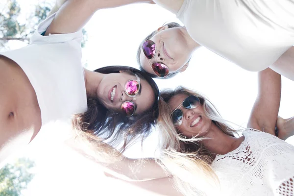 Underneath view of female friends with smiling faces outdoors — Stock Photo, Image