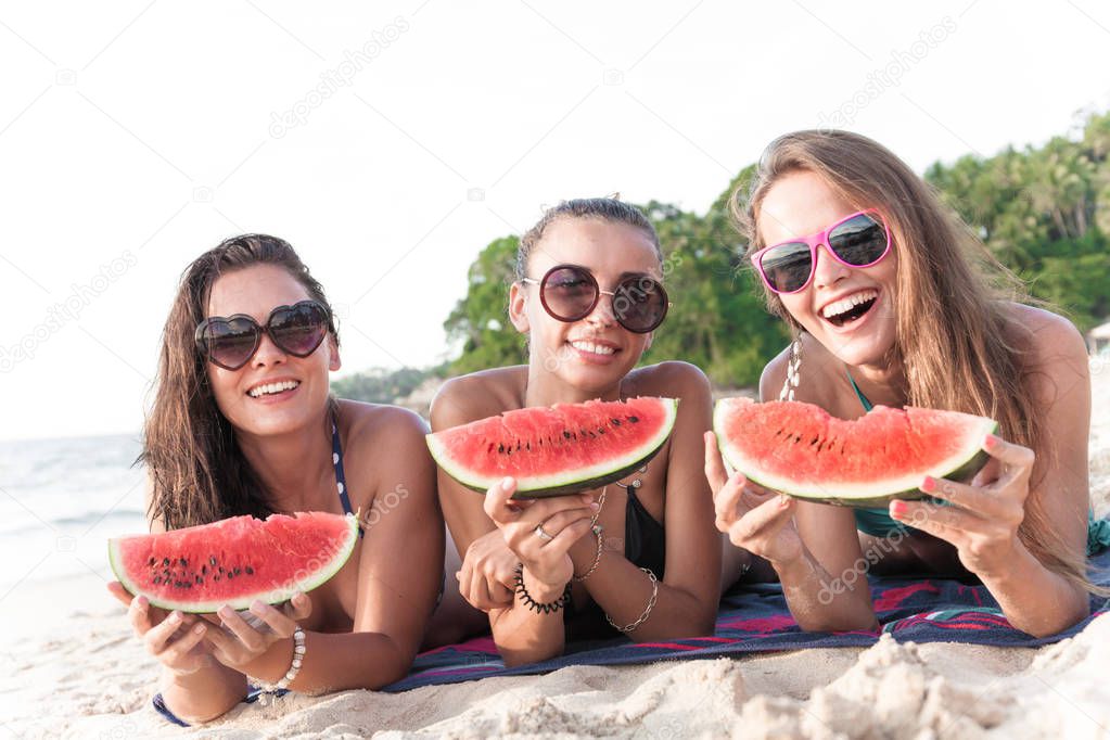 Female friends eating watermelon