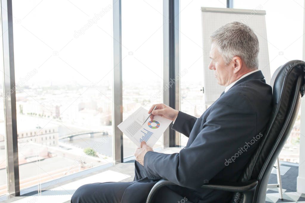 Businessman looking at diagrams