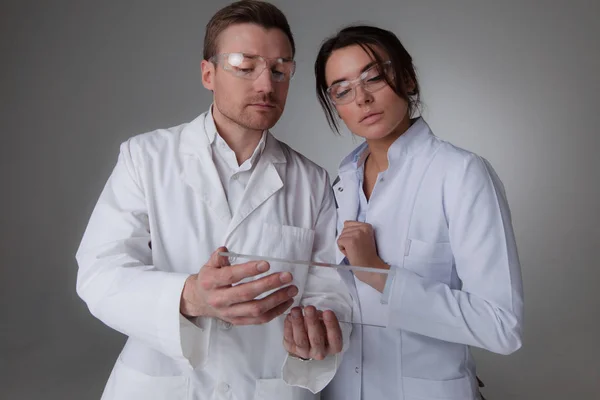 Two scientists with futuristic tablet