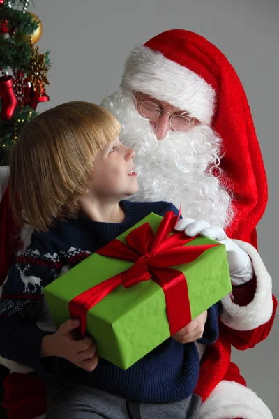 Niño en santa claus rodillas — Foto de Stock