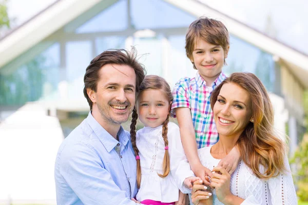 Happy family and their house — Stock Photo, Image