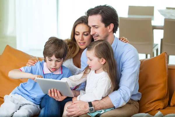 Счастливая семья с планшетным ПК — стоковое фото