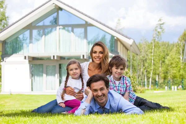 Happy family and their house — Stock Photo, Image