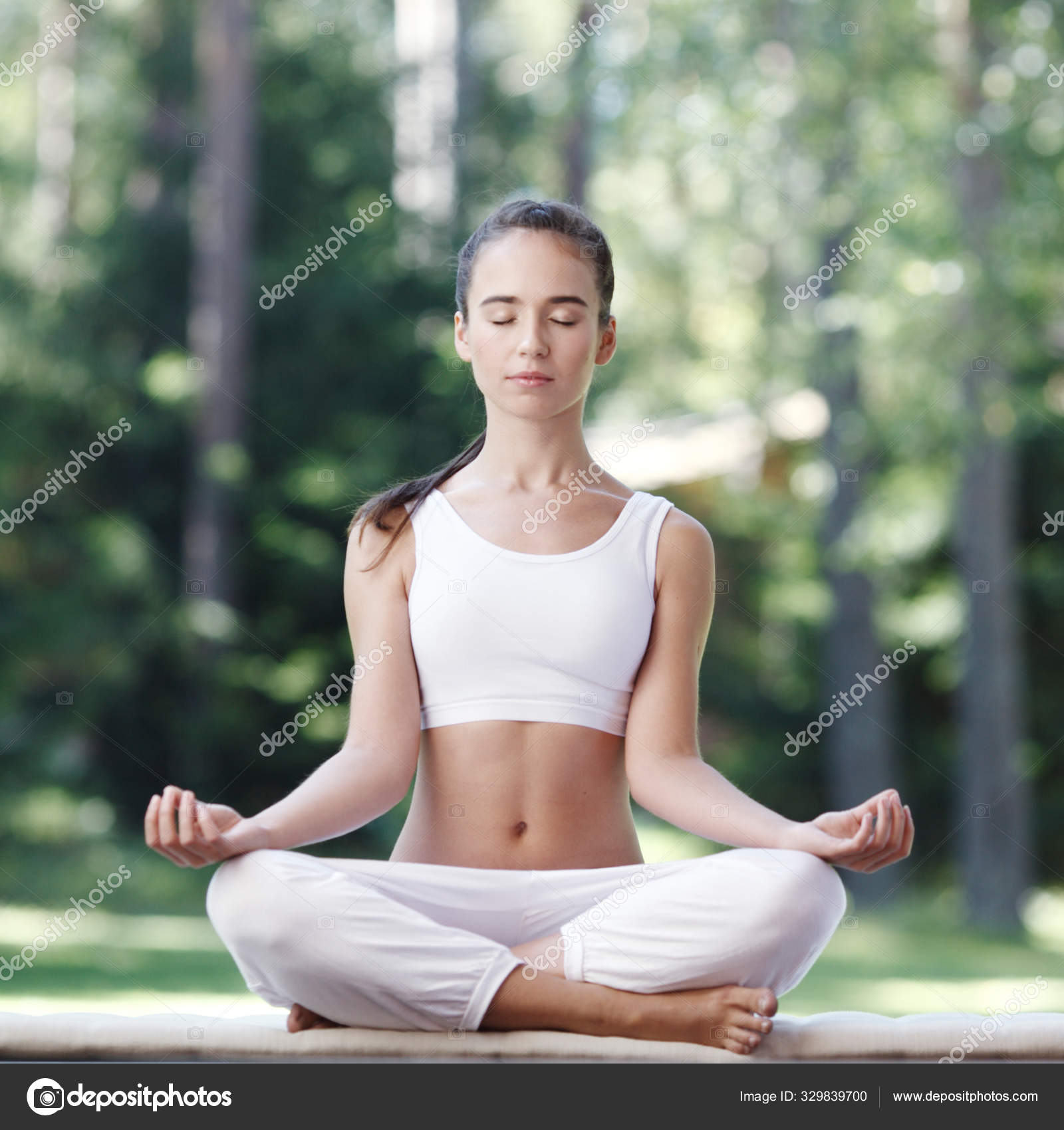 Woman doing yoga exercise Stock Photo by ©ALotOfPeople 329839700