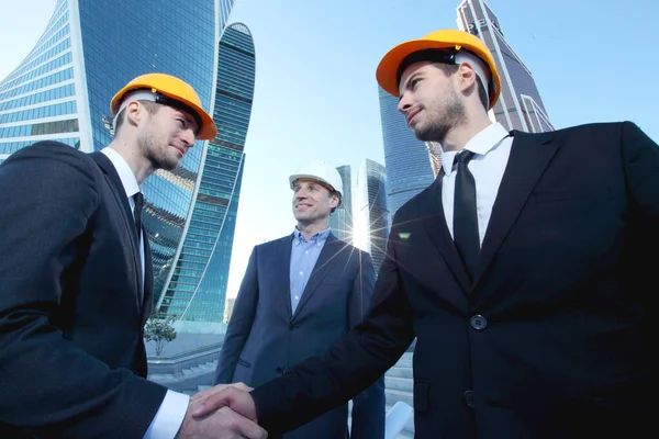 Architect Engineers Shaking Hands Construction Site Skyscrapers Background — Stock Photo, Image