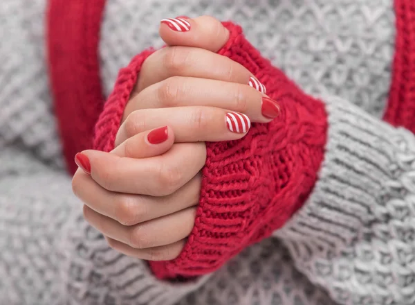 Hands warm the mittens.
