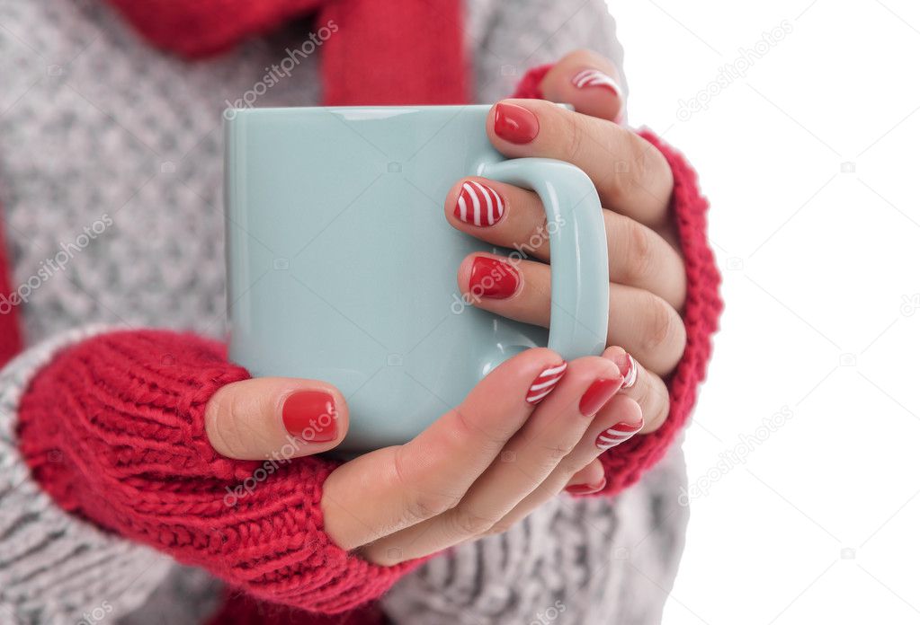 Cup of tea in female hands.