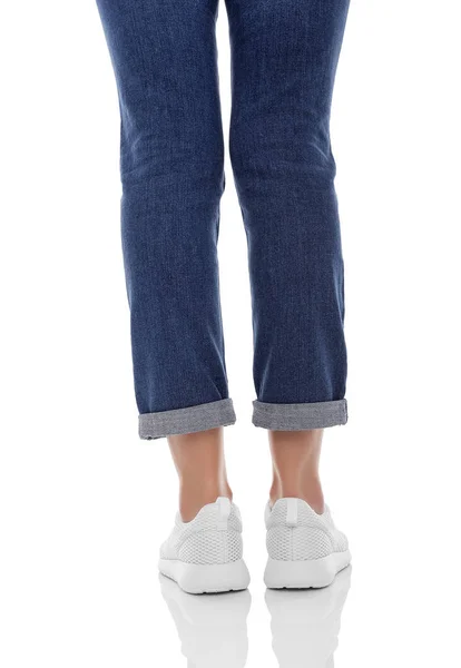 Pernas de mulher em jeans e tênis. — Fotografia de Stock