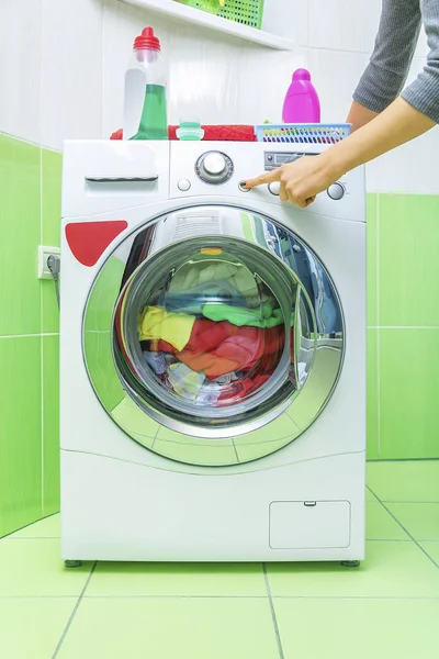 Kadının el çamaşır makinesi üzerinde bir düğmeye basmadan. — Stok fotoğraf