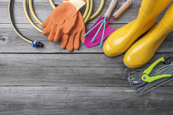 Rubber boots and garden tools.