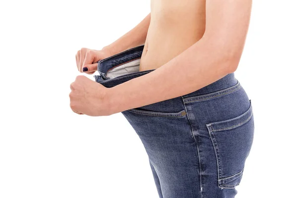 女性は、彼女が重量を失ったことを示します。大きなジーンズ. — ストック写真