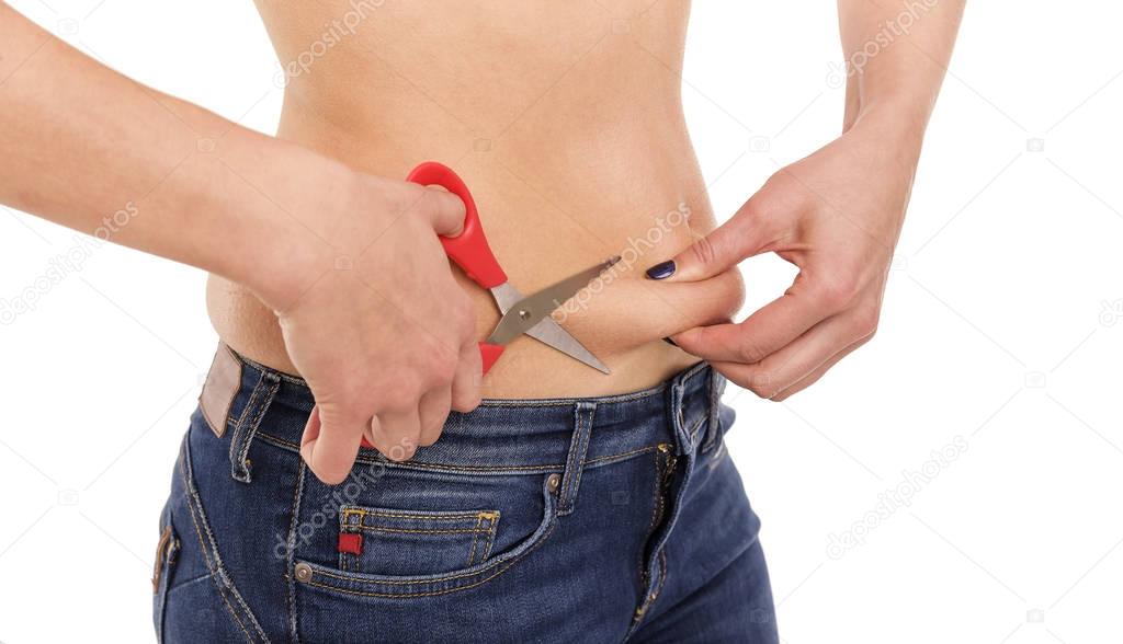 Scissors cut off excess fat at the waist.