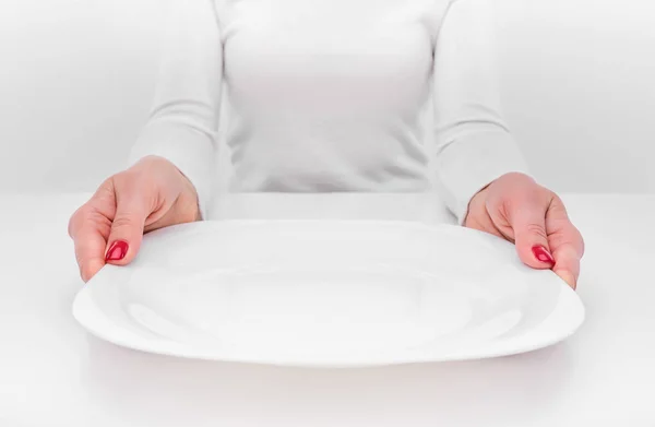 Female hands and an empty plate. — Stock Photo, Image