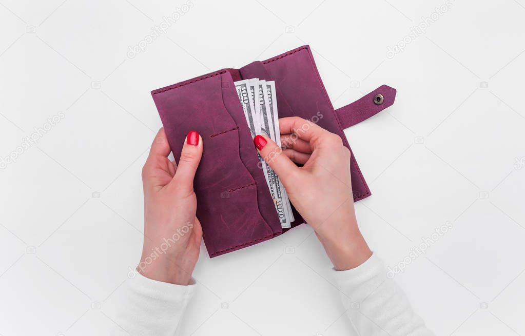 Purse with money in female hands.