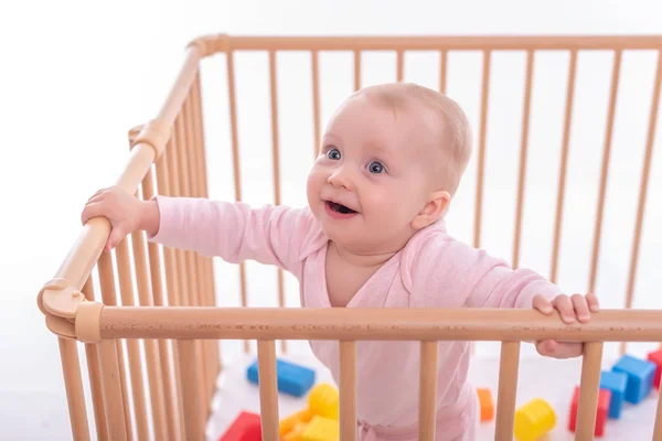 Baby girl at childrens playpen. — Stock Photo, Image