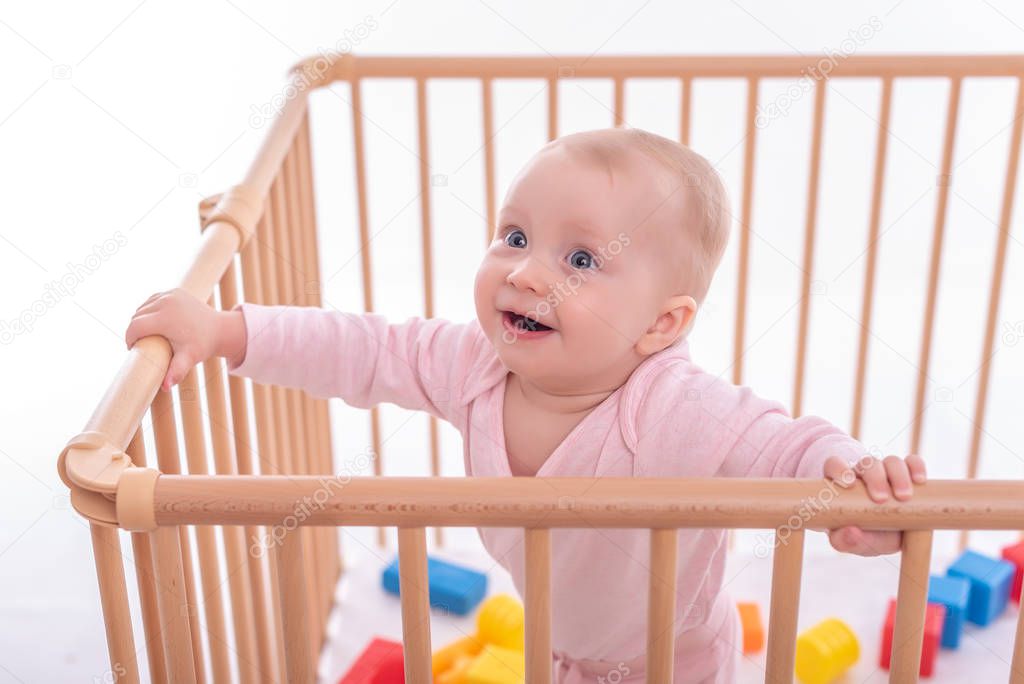 Baby girl at childrens playpen.