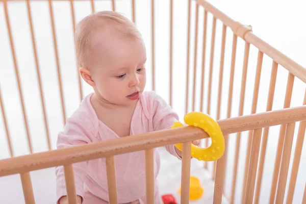 Baby girl at childrens playpen. — Stock Photo, Image