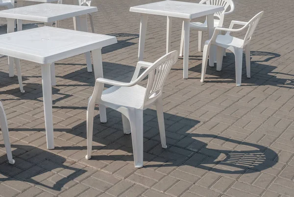 White plastic chairs and tables, background — Stock Photo, Image