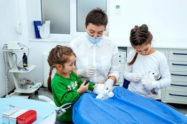 Treatment office children dentist teeth small girl teen red doctor new year discount woman clean clinic quietly comfortably — Stock Photo, Image