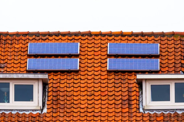 Red tile Roof with solar panels. New solar technologies on the old house.