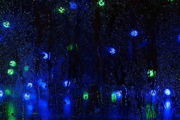 Desenfoque lluvia gota ventana calle noche noche luz bokeh abstracto fondo — Foto de Stock