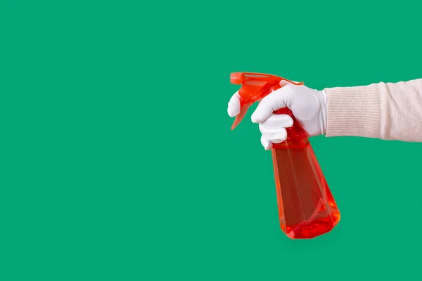 Glove hand green background spray dispenser one red clean copy space — Stock Photo, Image