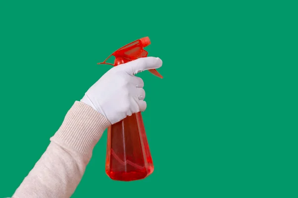 Glove hand green background spray dispenser one red clean copy space — Stock Photo, Image