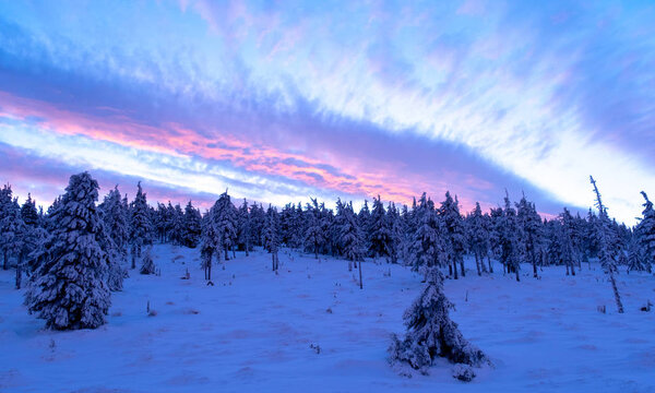 Sunrise or sunset in the winter mountains landscape. Pink and blue clouds in the morning in Poland.