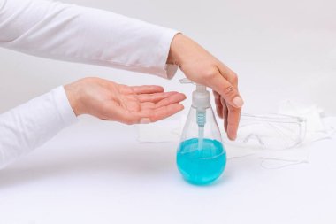 Kadınlar jel veya antibakteriyel sabunla ellerini yıkıyorlar. Doktorun elinin beyaz arka planda şeker kutusuyla yakın plan fotoğrafı..