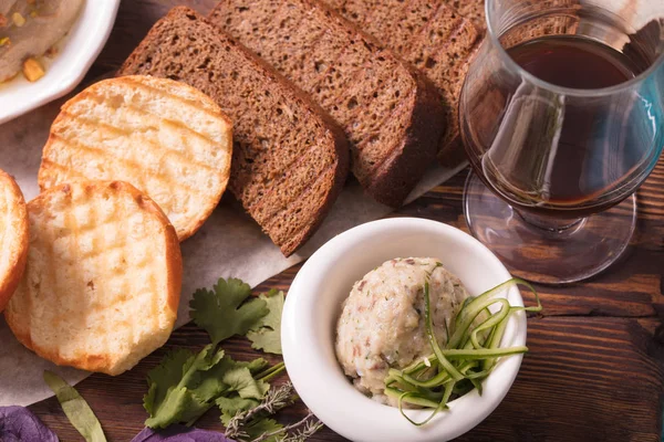 A light snack of toast and pate with nuts. Toast, bread, pate and greens