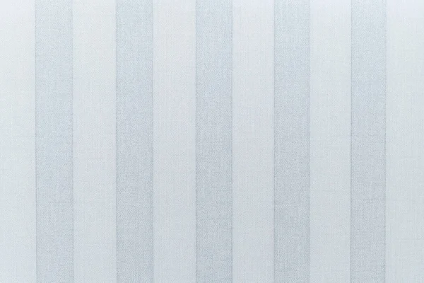 Paper Wallpaper on the wall with the texture of linen. Wide Vertical gray-blue stripes Wallpaper. The texture of the Wallpaper is linen.