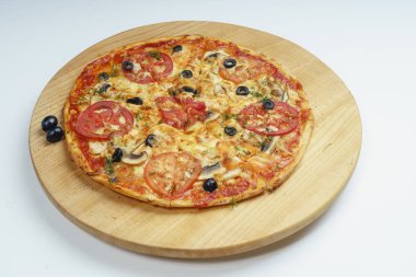 Dilimlenmiş sosisli, peynirli, zeytinli ve domatesli pizza. Pizza parçalara ayrılmış, biri diğerinden uzaklaştırılmış..