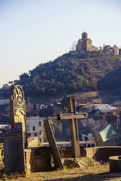Old crosses and tombstones. In the background on the hill - Tabor Monastery of the Transfiguration