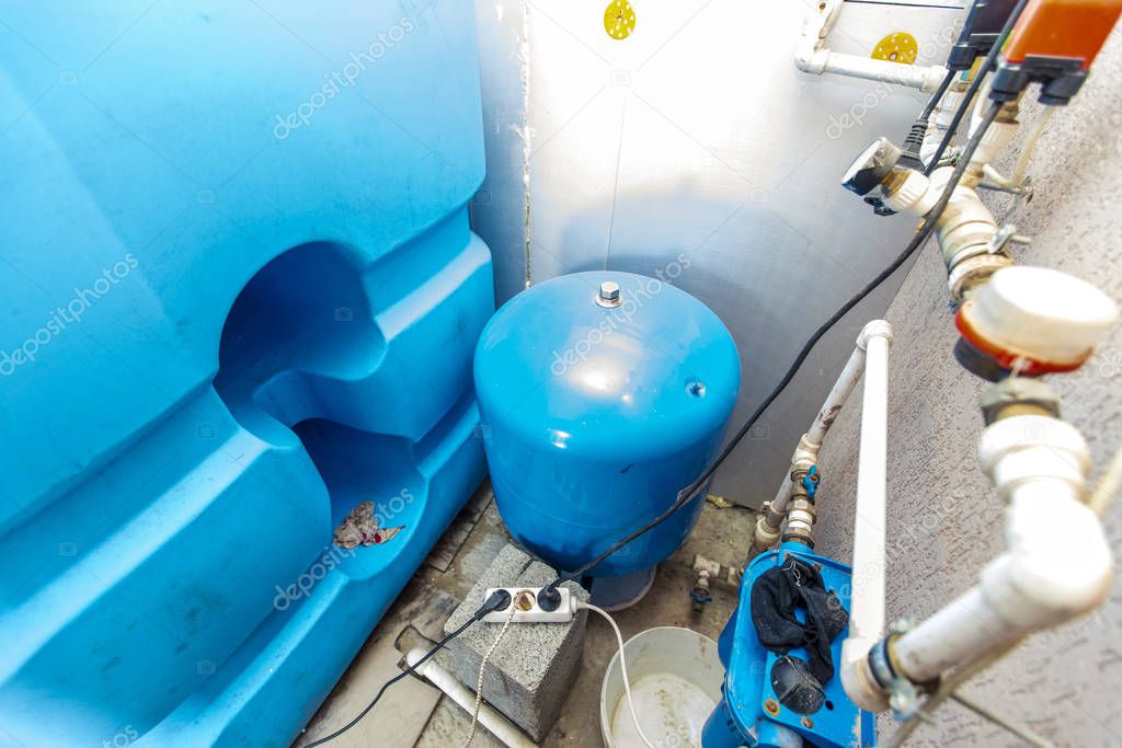 water tanks and pumps for water supply in the basement of the cottage