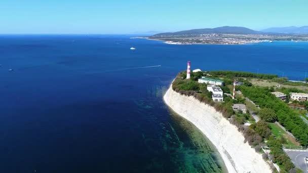 Flyg längs de höga vita klipporna i Svarta havet till Gelendzhiks fyr, belägen på "tjock" udden i semesterorten Gelendzhik — Stockvideo