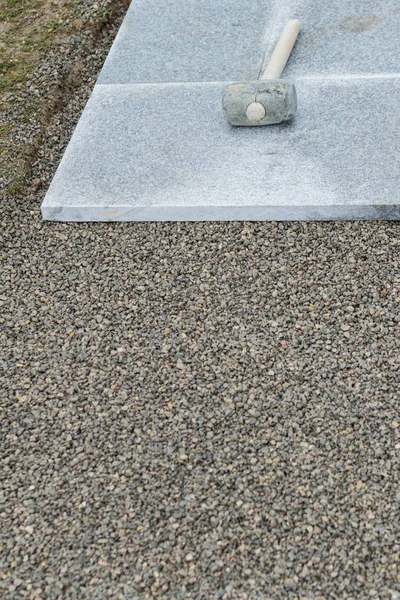 Rubber hammer laying on the stone plate — Stock Photo, Image