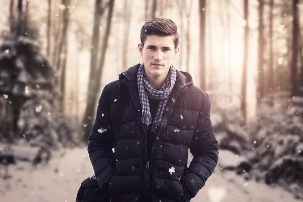 portrait of young man with jacket in front of blurred winter for