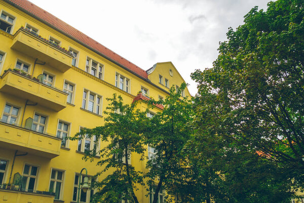 Yellow apartment house in low angle view