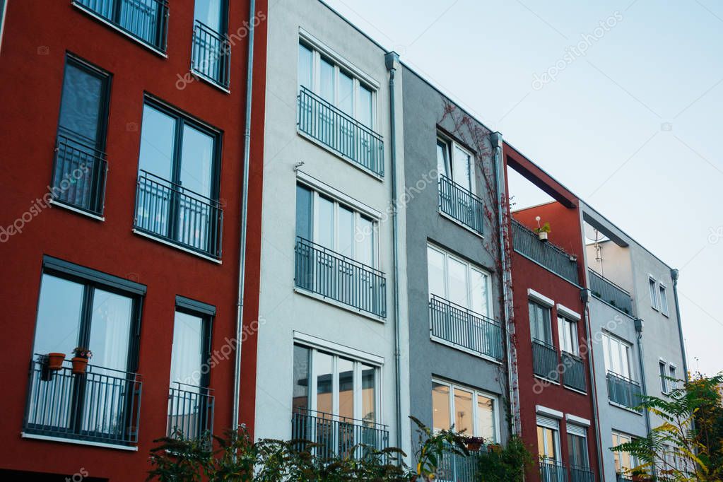 townhouses with green bushes on the ground