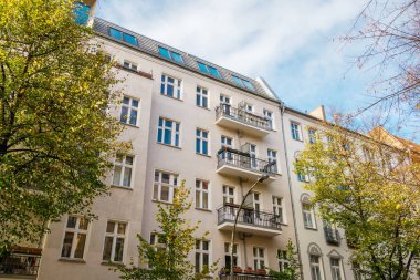 white modern apartment buildings in a street at berlin