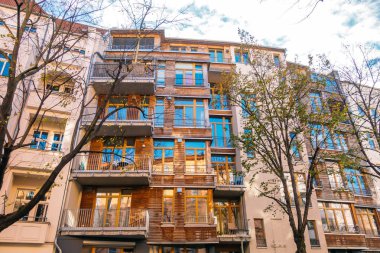 wooden modern apartment building with steel balcony
