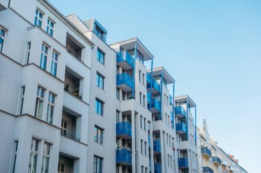 modern white facaded apartment complex with futuristic roof