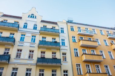 yellow and orange residential houses in low angle view